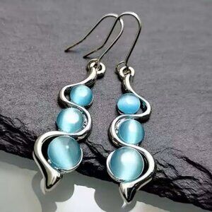 Silvery Curved Wave Earrings Adorned with Light Blue Moonstone Drops Z275